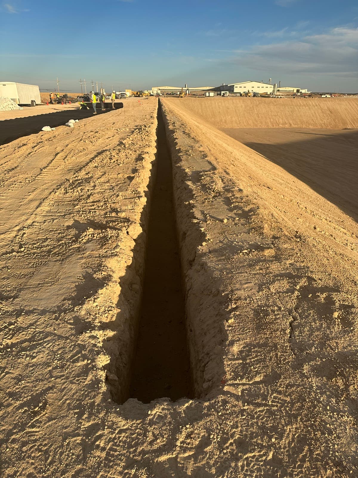Anchor trench construction around lagoon perimeter